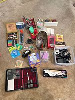 Overview of all mixed office supplies spread on carpet