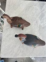 Top view of both wooden duck decoys on stands