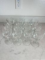 All 12 clear stemmed cordial glasses displayed on countertop