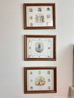 Full view of the three framed prints mounted vertically on wall