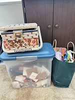 Wicker sewing basket on plastic tote beside paper bag