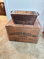 Crate front with insert positioned on top showing side stencil text