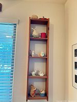 Full view of narrow wall shelf with all contents