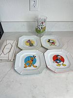 Four Disney character plates, Goofy glass and four plate hangers