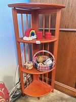 full view of wood corner shelf with items displayed