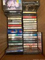 Open box showing rows of cassettes including Steely Dan Gold