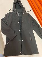 Full view of black Nautica hooded rain jacket laid flat showing front, zipper, snap placket, pockets