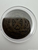 Obverse of 1837 half penny token in capsule