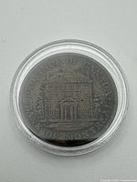 Obverse view of 1842 Bank of Montreal half-penny token in clear capsule