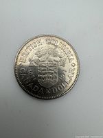Reverse side showing British Columbia coat of arms, 1871-1971 dates and CANADA DOLLAR legend