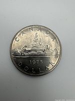 Reverse side of 1975 Canadian dollar coin showing canoe design