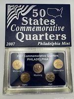 Front of boxed set showing sleeve and mounted coins