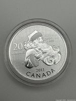 Obverse view of 2013 $20 Santa Claus silver coin in capsule