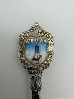 Close-up of enamel Algarve crest and ornate finial