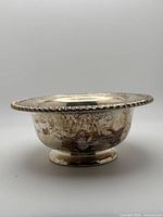 Side view showing beaded rim and tarnish on body