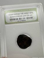 Encapsulated Roman coin showing certification label and holder