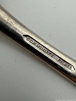 Close-up of Community Plate hallmark on handle
