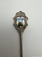 Close-up of handle showing DAMASCUS enamel crest and ornate metalwork