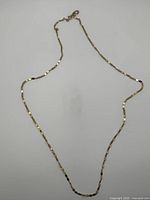 Full view of the gold-tone flat link necklace laid out