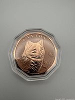 Obverse view of copper coin featuring wolf design