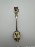 Full view of spoon showing crest, handle and bowl imagery