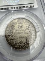 Reverse of 1912 50¢ coin showing denomination, date, maple leaves