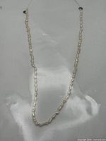 Full view of pearl necklace laid flat