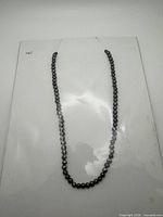 Full view of entire pearl necklace laid flat