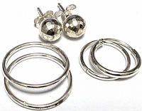 Front view of all three earring pairs: faceted ball studs, small hoops, medium hoops