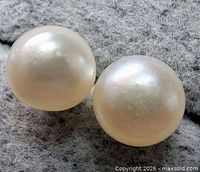 Close-up of both round freshwater pearls displaying lustre and surface