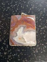 Front view of rectangular agate pendant in silver bezel