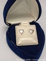 Earrings displayed in velvet heart box