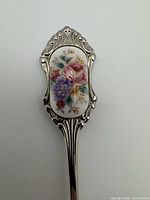 Close-up of handle showing floral cameo decoration and ornate detailing