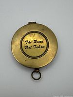 Closed compass showing external engraving "The Road Not Taken"