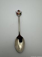 Full view of spoon front showing bowl and enamel crest