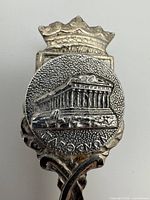 Finial close-up showing Parthenon relief and crown