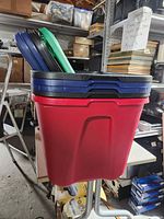 stack of 5 lids resting in red tote