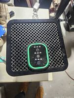 Top view showing grille and green-trimmed control panel