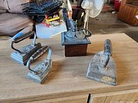 Group shot of three irons and coffee grinder