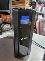 Front view showing APC logo and illuminated LCD