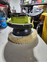 Side view of Ryobi polisher with wool pad