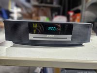 Front view showing display, CD slot, logo