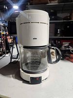 Front view of Braun white drip coffee maker with carafe