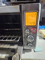 Front angled view showing LCD display, control knobs and open door