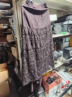 Full view of skirt hanging, showing length and overlay