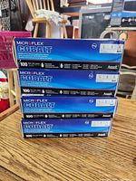 Stack of four sealed boxes of Microflex Cobalt gloves showing front labels