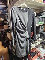 Front view of two-tone long sleeve dress showing asymmetrical ruching