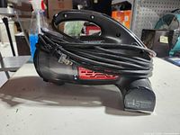 Left side view of Dirt Devil hand vac showing handle, dust cup, cord