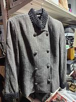 Front view of pinstripe wool coat on hanger