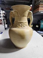 Full view of vase front showing elephant head handles and decorative band